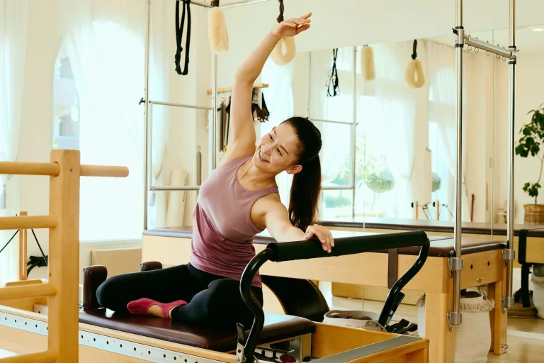 Woman exercising on reformer pilates machine