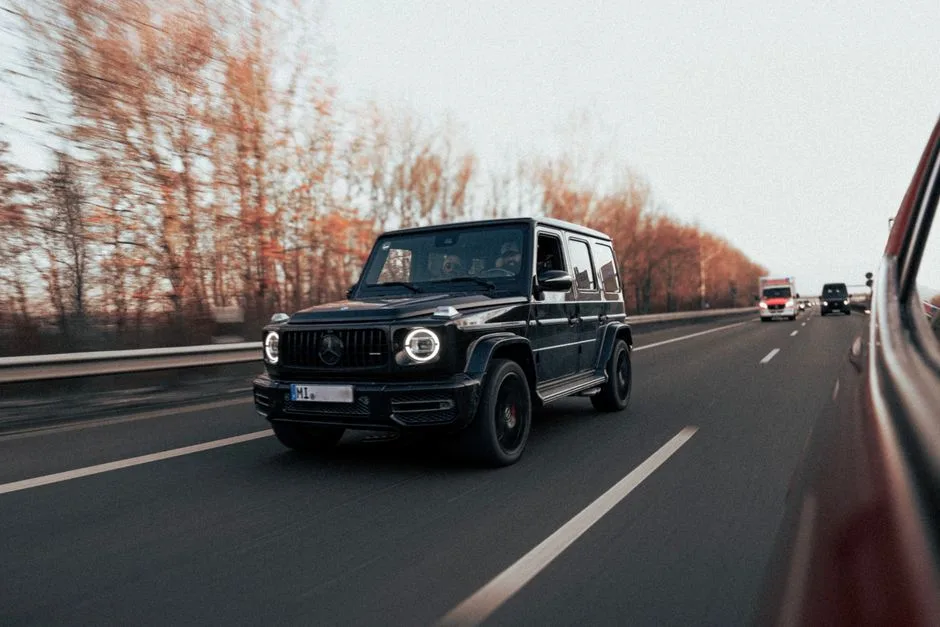 Luxury car interior with plush leather seats, advanced dashboard technology, and spacious cabin during a scenic road trip.